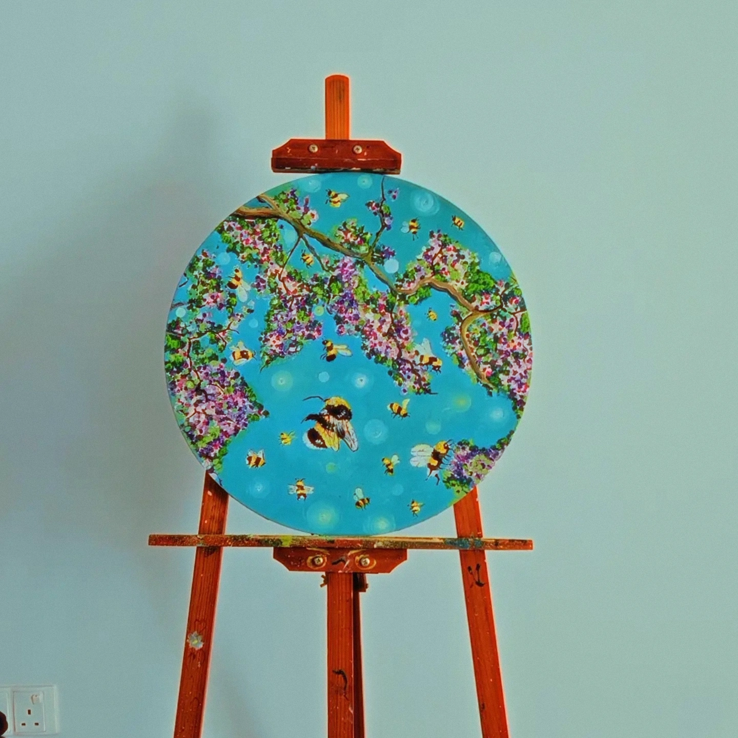 "Life is going on" by Alagoz Osmanova, circular canvas with blossoming flowers and bees