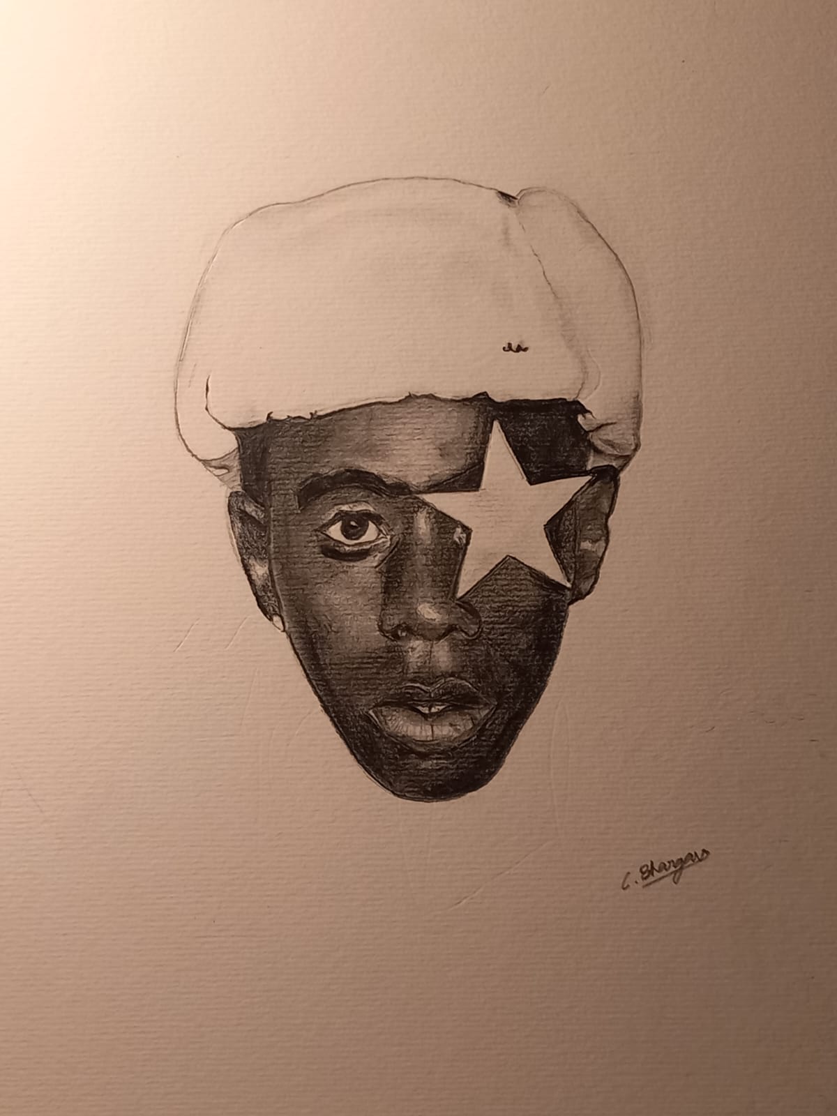 Winter Star by Bhargav Chandrasekar, monochromatic sketch of a young man's face with a warm hat