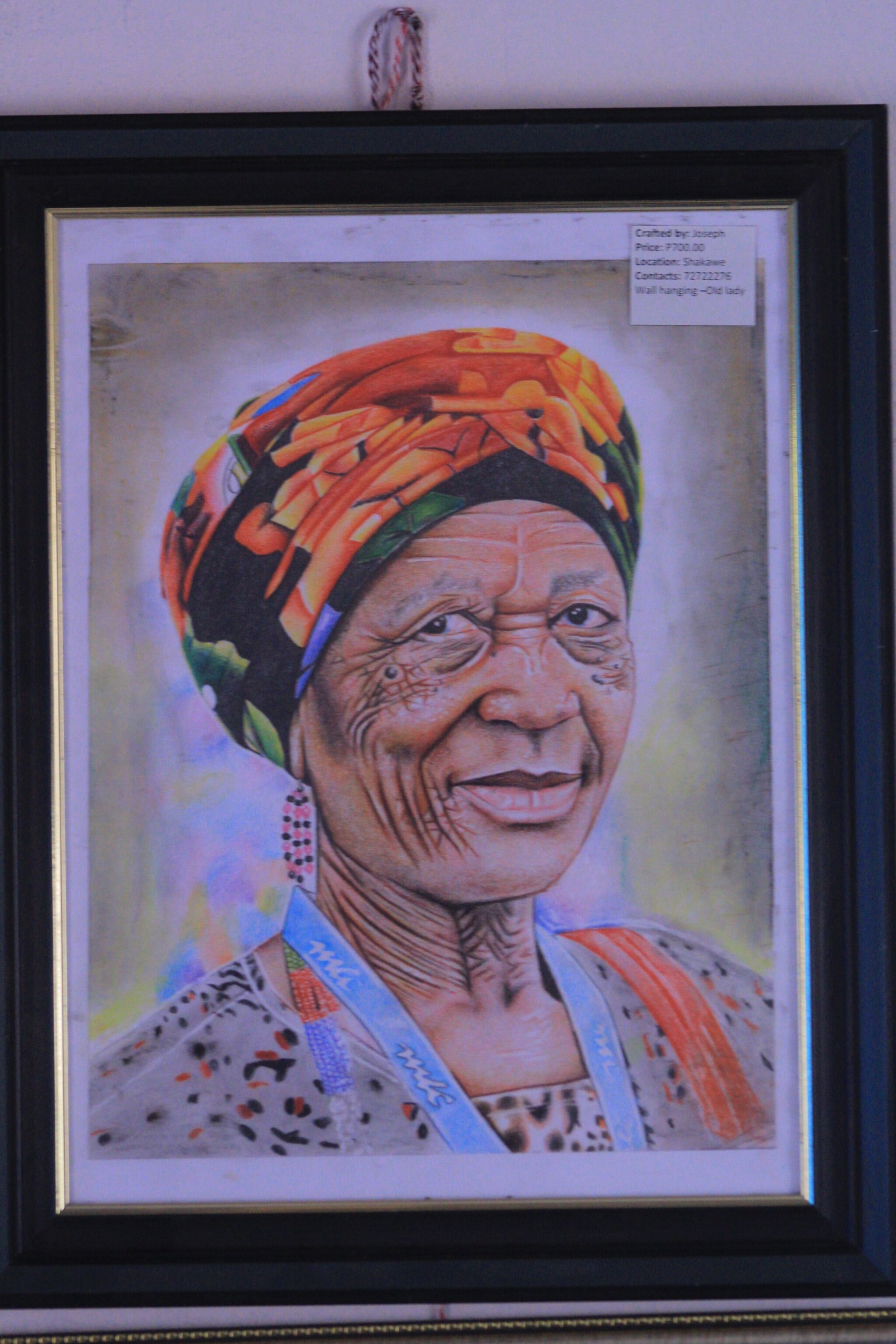 Matriarch of Shakawe by Onalethata Joseph, portrait of elderly woman with a colorful headscarf