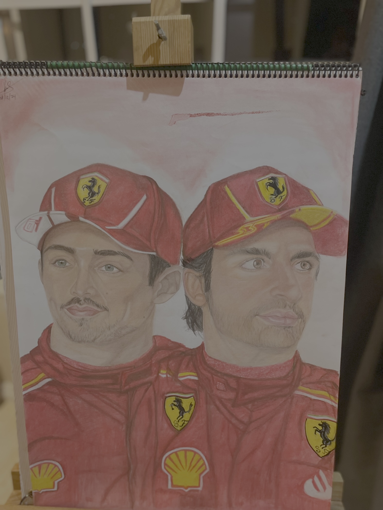 Charlos by Kyra Jade Gopal, featuring two figures in red Ferrari racing uniforms
