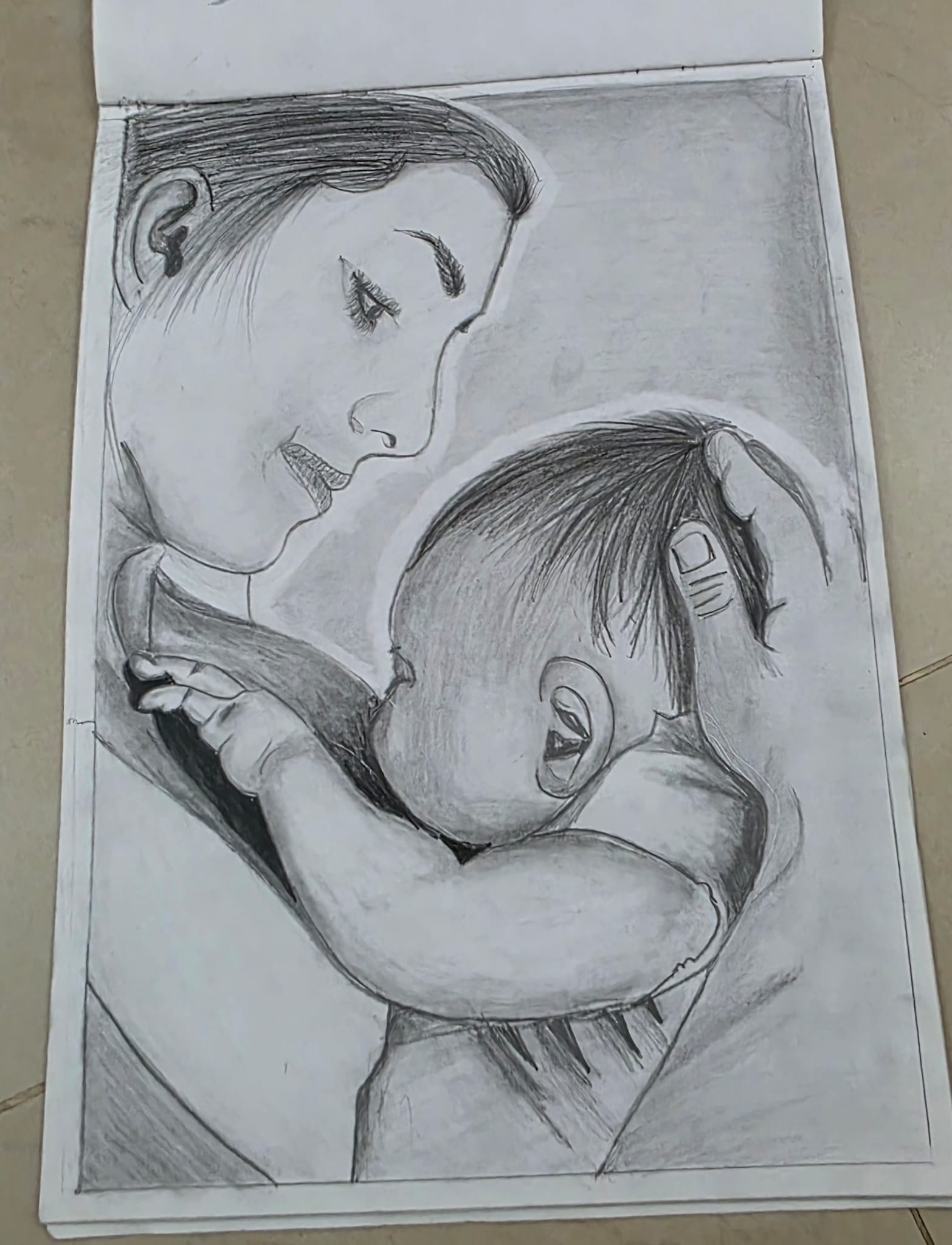 Pencil sketch of mother and son by Mishri Maheshkumar Patel, depicting a serene mother and baby