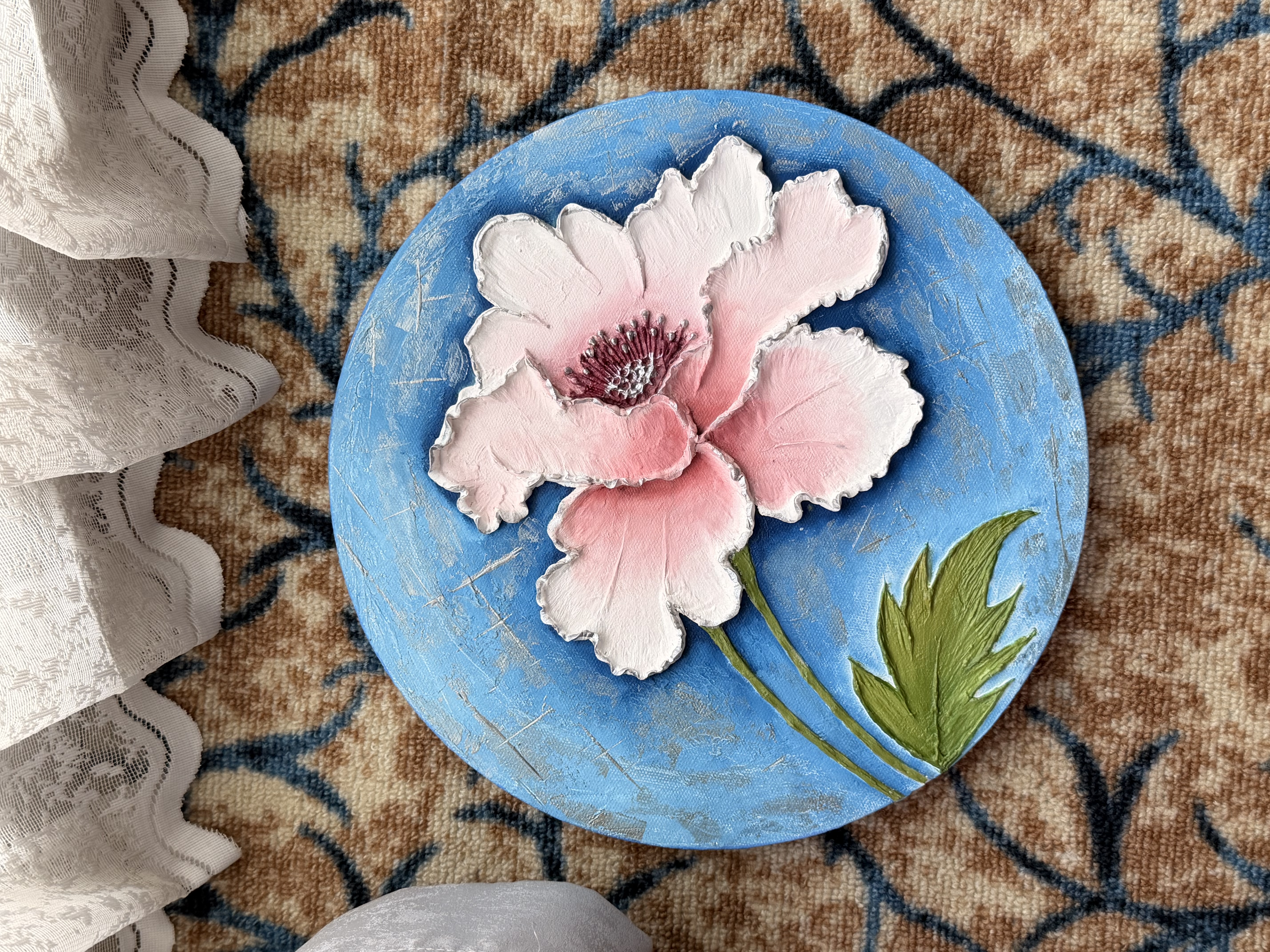 Petals of Serenity by Zainab Fatepurwala, pink flower with textured petals on a blue background
