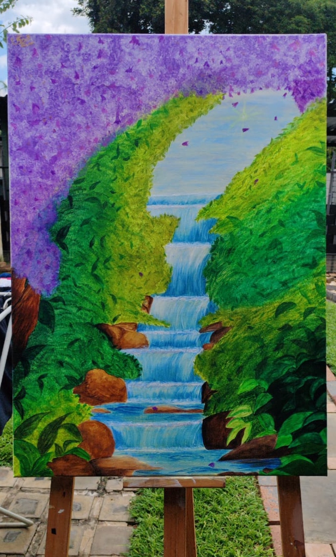 The subtle whispers of serenity by Kaitlyn Sewshanker - a waterfall amidst lush greenery