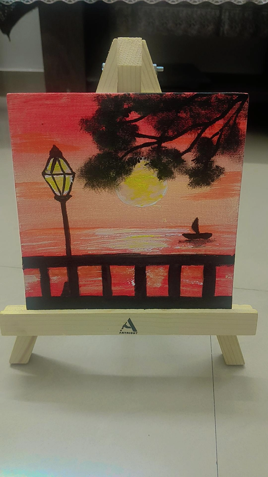 Whispers of Dusk by Varuni Sinha, a serene sunset scene with warm hues and silhouetted lamppost
