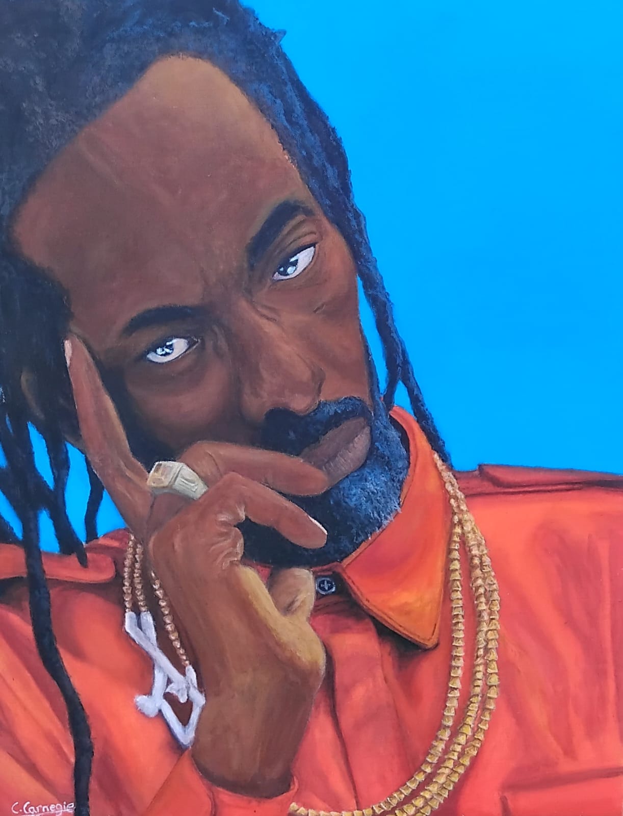 Gargamel by Cammare Carnegie, a contemplative man with dreadlocks and a red shirt