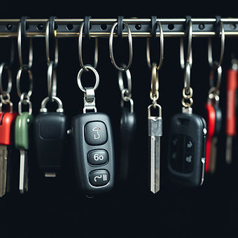 front view out of focus image of a list of different car keys hanging on hooks.jpg