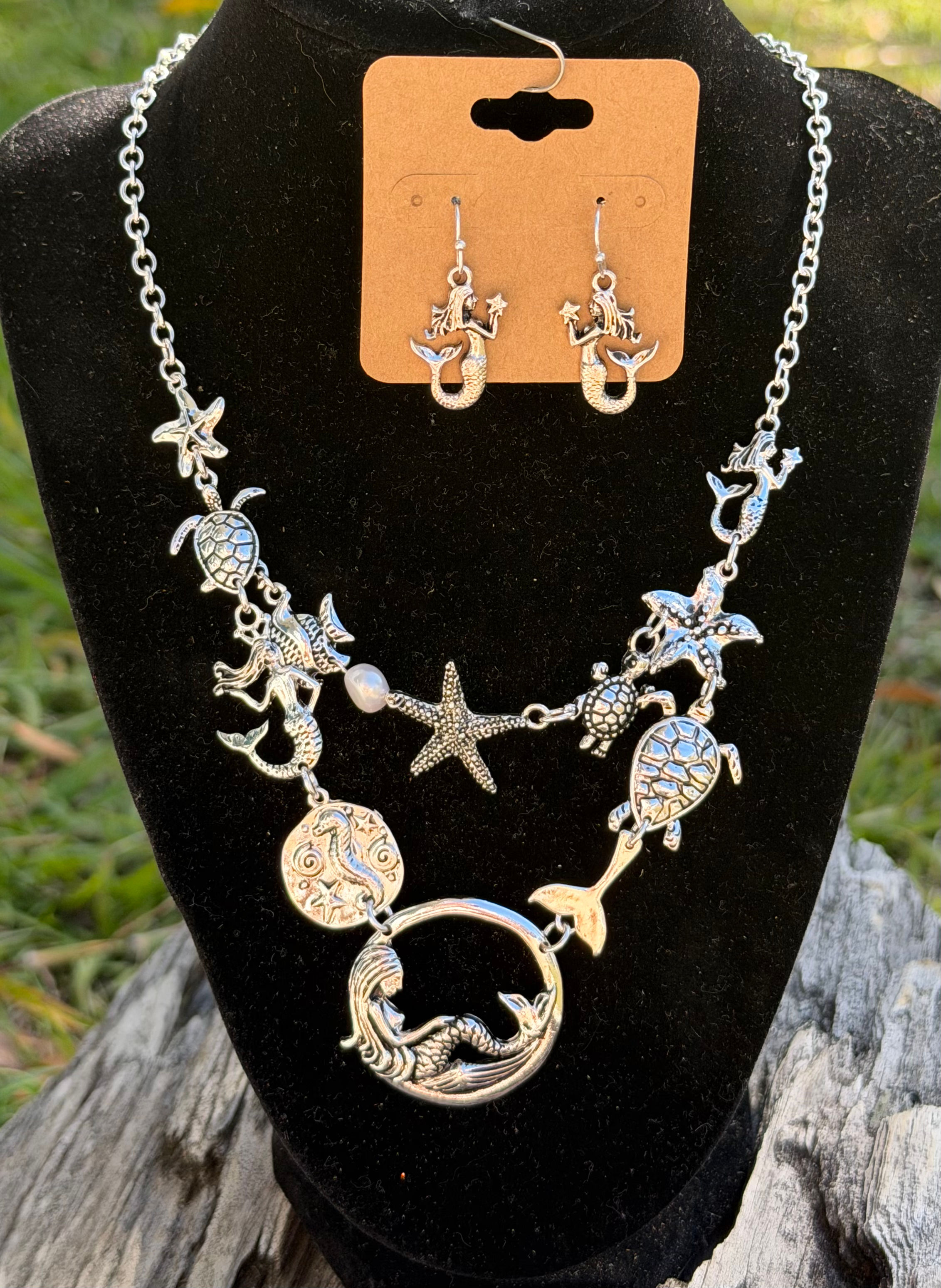 Mermaid necklace with coastal features with matching earrings.