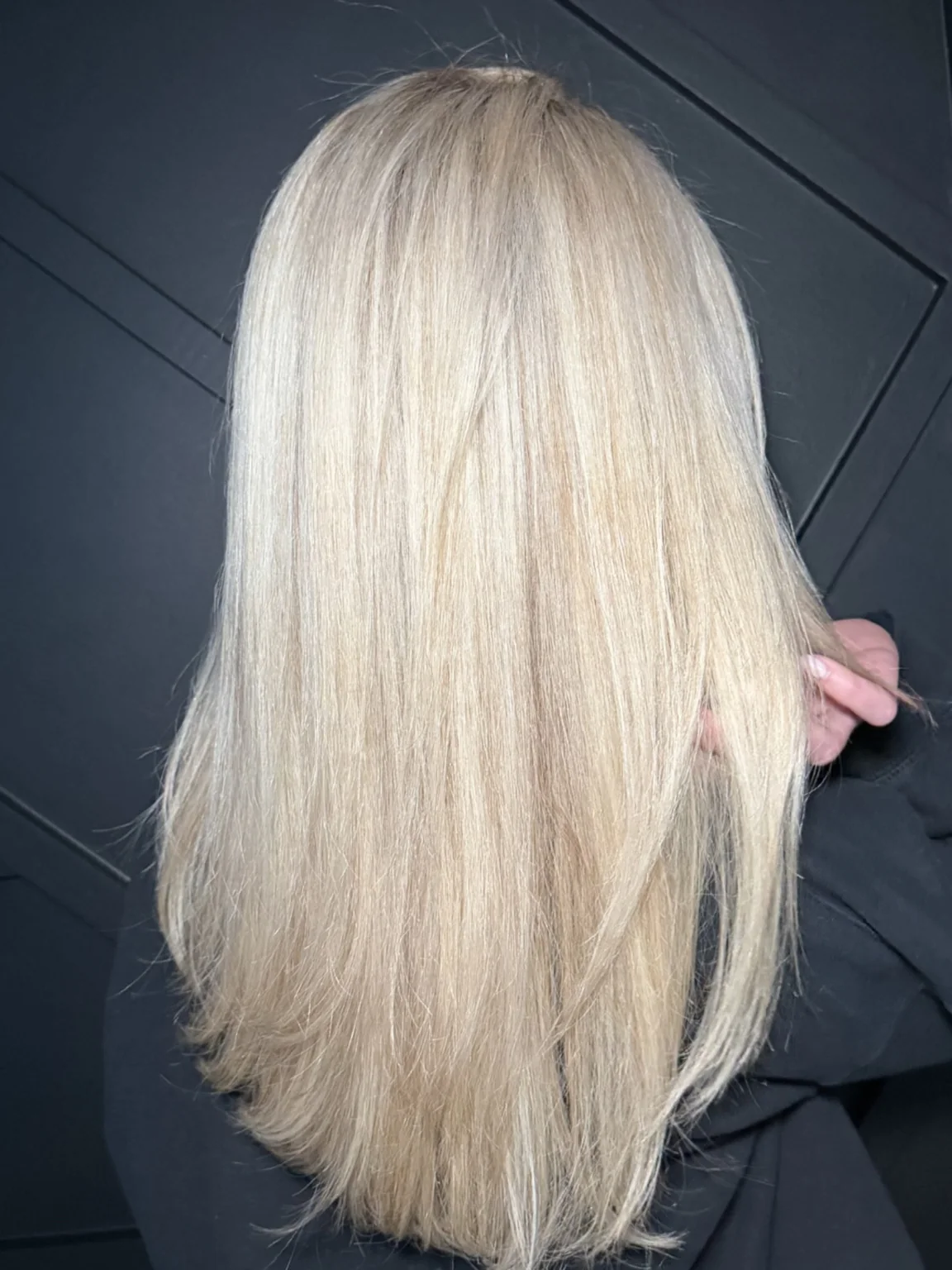 Sleek platinum-blonde hair with a glossy straight finish