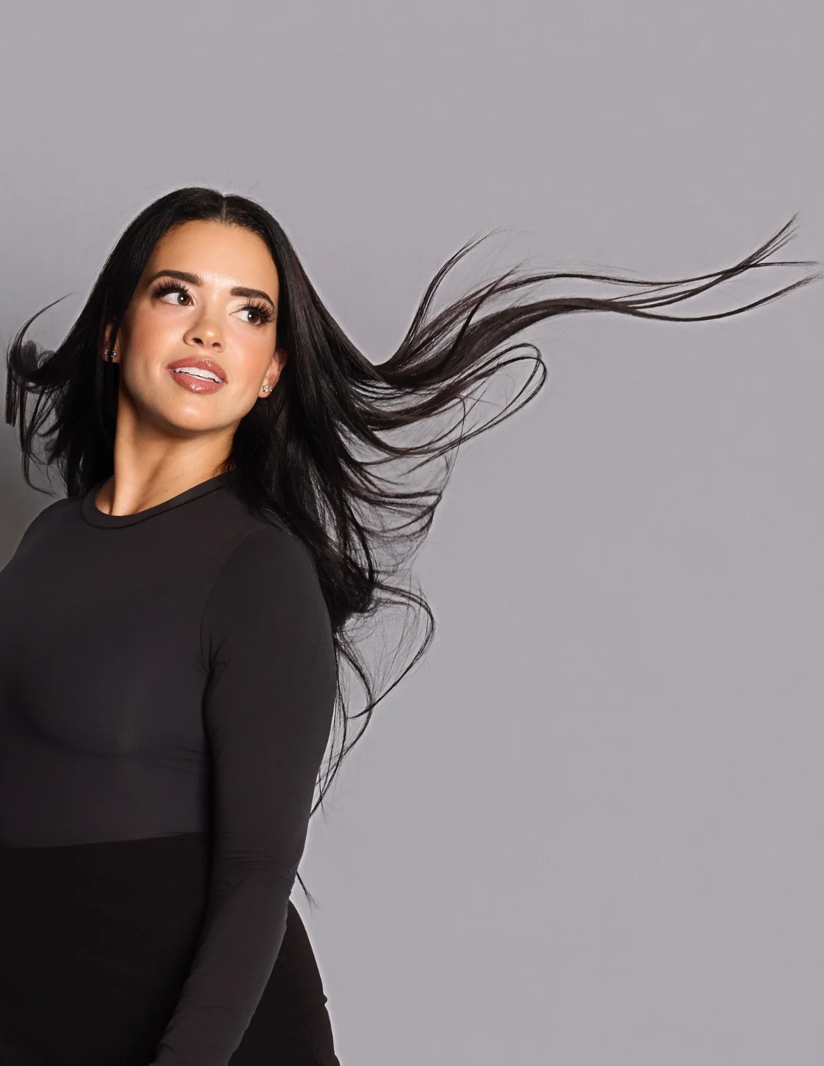Editorial beauty portrait featuring long dark hair styled in motion