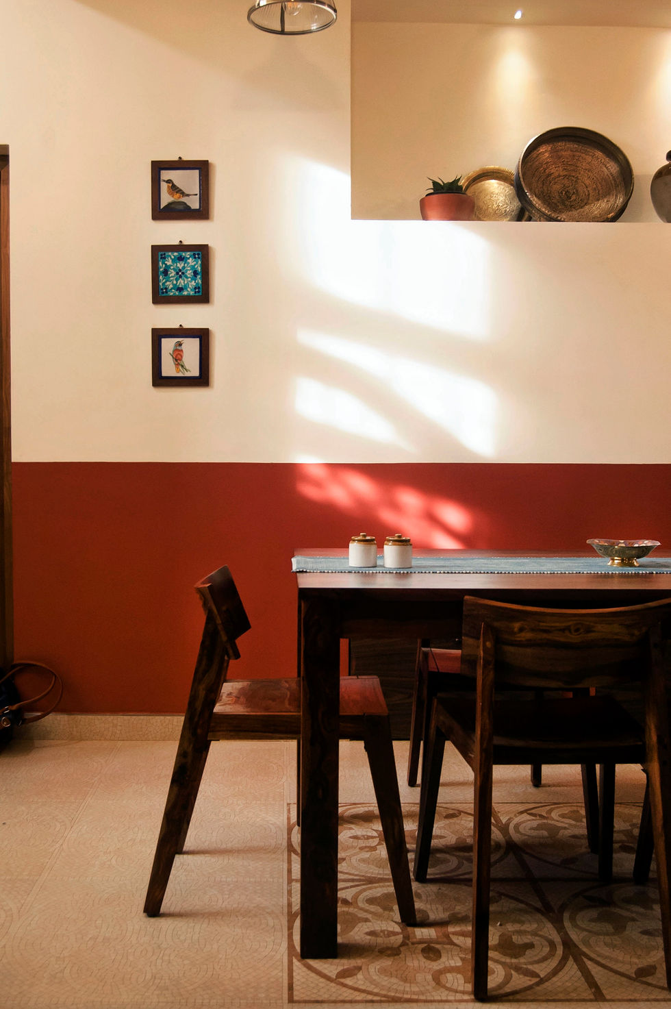 a dining room with red and white walls and a table and chairs