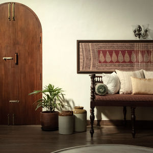 a living room with a wooden bench and a picture on the wall