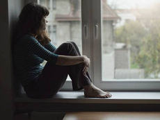 Young person sitting alone and reflecting on mental health