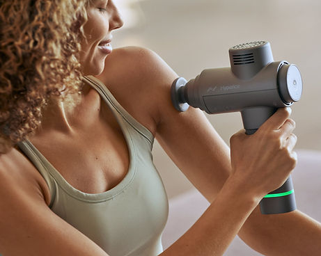 woman using hypervolt 2 on her upper arm