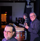 Grupo KaChe conguero playing live percussion at a Houston event venue, adding authentic Latin rhythms to a high-energy entertainment experience.