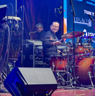 Grupo KaChe drummer and percussionist performing live at a Houston event venue, delivering energetic Latin rhythms and live entertainment for guests.