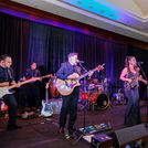 Grupo KaChe premium entertainment package featuring more than 10 musicians performing Latin and variety music at a Houston event venue with a high-energy live band experience.