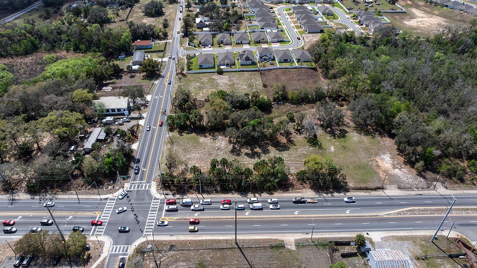 Aerial view of suburban road intersection and undeveloped land