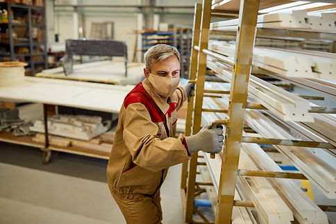 male-worker-with-face-mask-moving-rack-with-processed-wood-carpentry-workshop.jpg