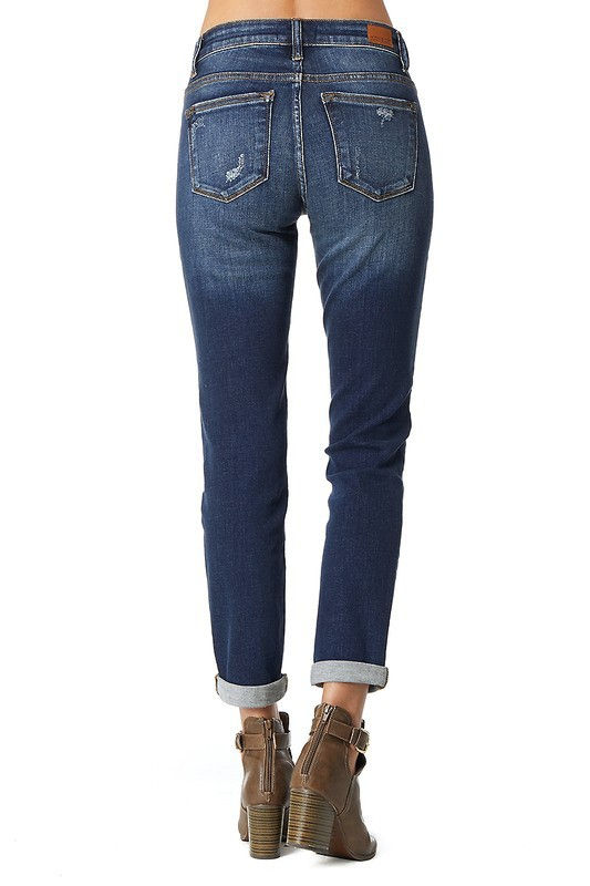Thumbnail: Back view of woman wearing jeans with faded bottom and cuffed hem.