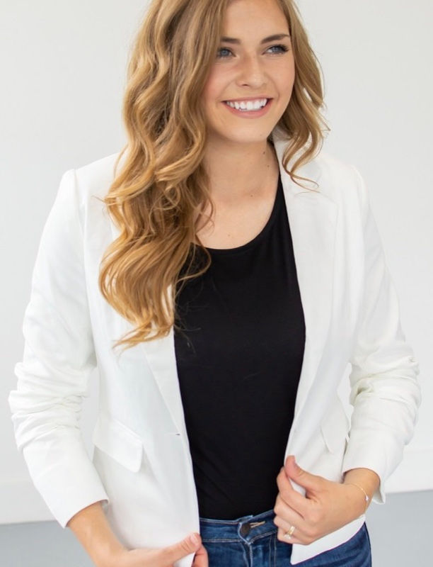 Thumbnail: Smiling woman wearing a white blazer and black shirt with Scroll Earrings.