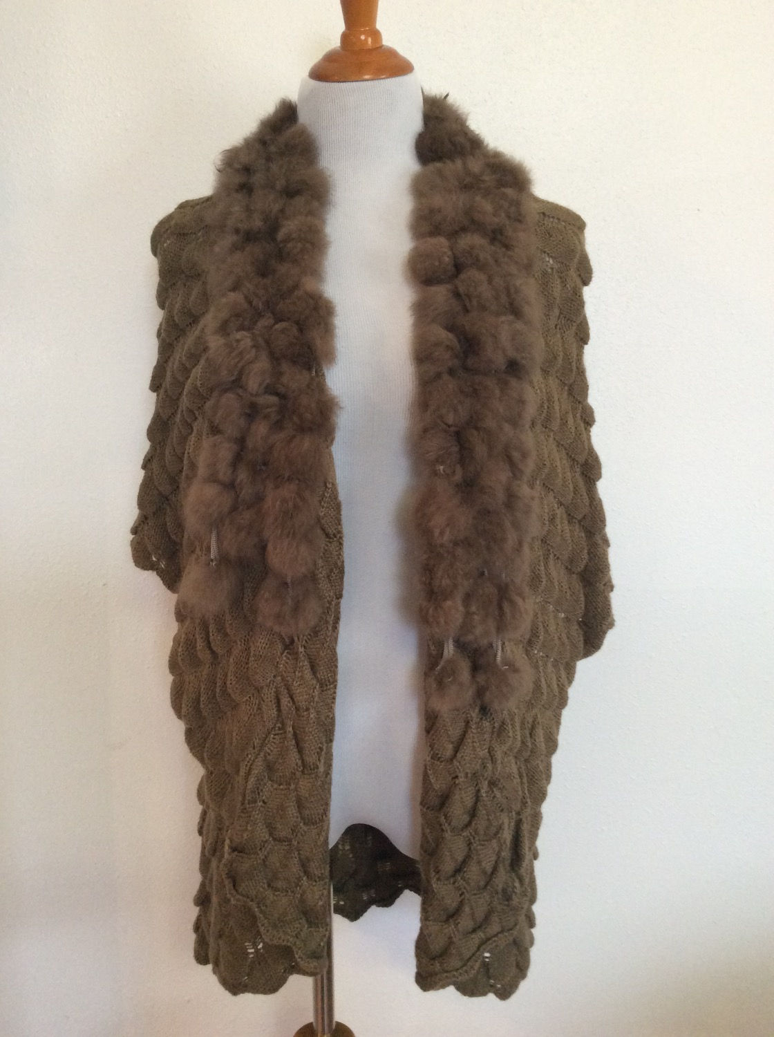 Brown fur shawl displayed. Soft, textured, and displayed against white background.
