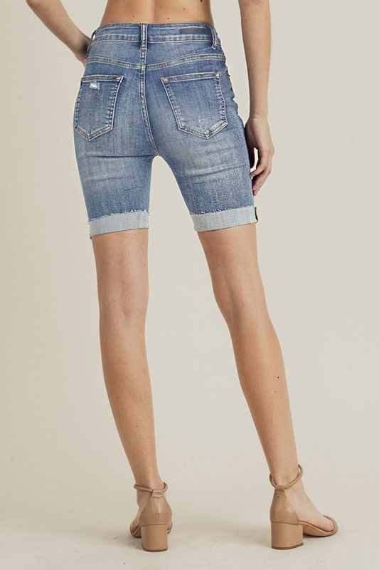 Thumbnail: Woman wearing blue denim shorts shows the back view with Off White Denim Shorts.