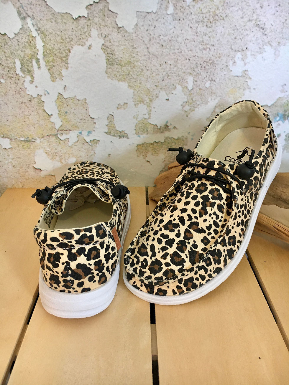 Thumbnail: Leopard print shoes with white soles against a textured background.