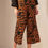 Thumbnail: Woman wearing patterned brown and black pants; fashion and style.