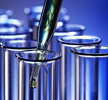 Test tubes with liquid being filled - Food & Drug Industry security and emergency management solutions