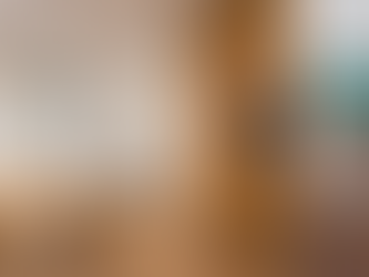 Woman uses a smart home control panel on a wall in a modern apartment with wooden floors, beige curtains, and a round table.