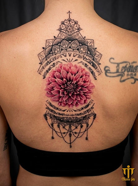 The client wanted a symmetrical, sacred piece to represent internal balance, mindfulness, and the blossoming of a new life chapter. I executed perfect, ultra-fine dotwork and geometric symmetry for the framing mandala, anchoring it with a vibrant, heavily saturated pink dahlia at the center. I aligned the design perfectly to create an elegant, ornamental centerpiece that feels deeply meditative and graceful.