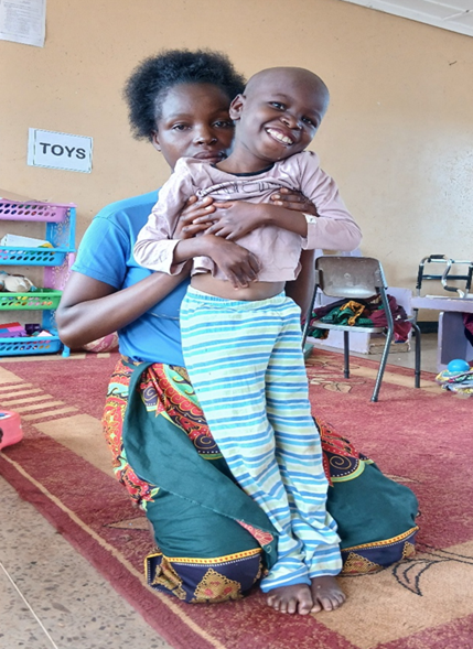 Ms. Nachula pose with her son Allinani in the Respite Home during the nutrition sessions for mothers at Victor Braun Special Needs School in Mbala, Zambia