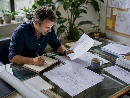Architect reviewing building regulations documents at home