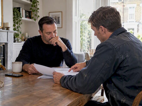 Homeowner and contractor reviewing renovation payment stages