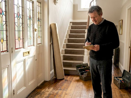 Homeowner inspecting Victorian hardwood flooring