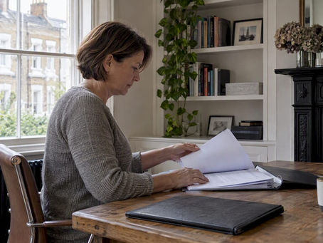 Homeowner filing electrical certificates at home