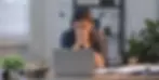 Stressed law school applicant covering her face at a laptop, illustrating why strong law school applicants get rejected