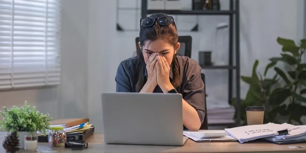 Stressed law school applicant covering her face at a laptop, illustrating why strong law school applicants get rejected