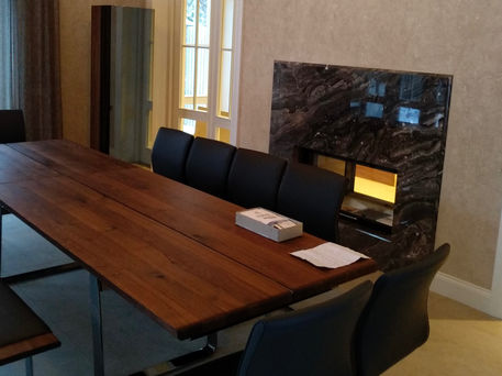 Living room with a fireplace featuring a stone surround and wood mantel