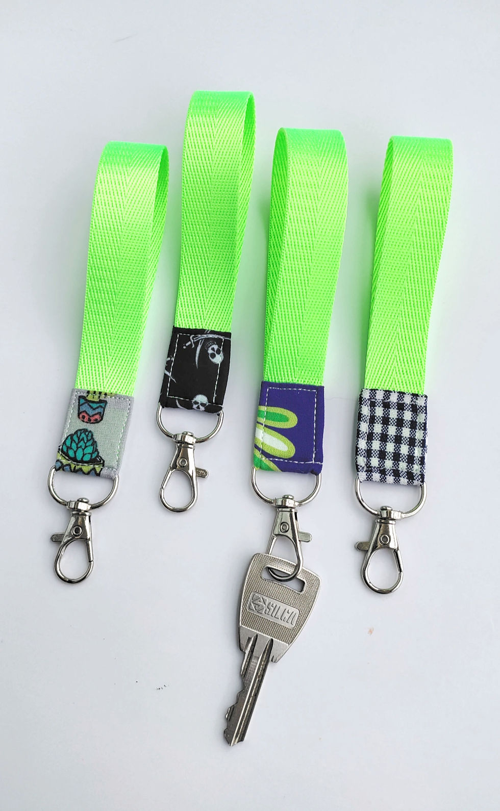 Thumbnail: handmade green neon fabric scraps wristlets keychain front view in use