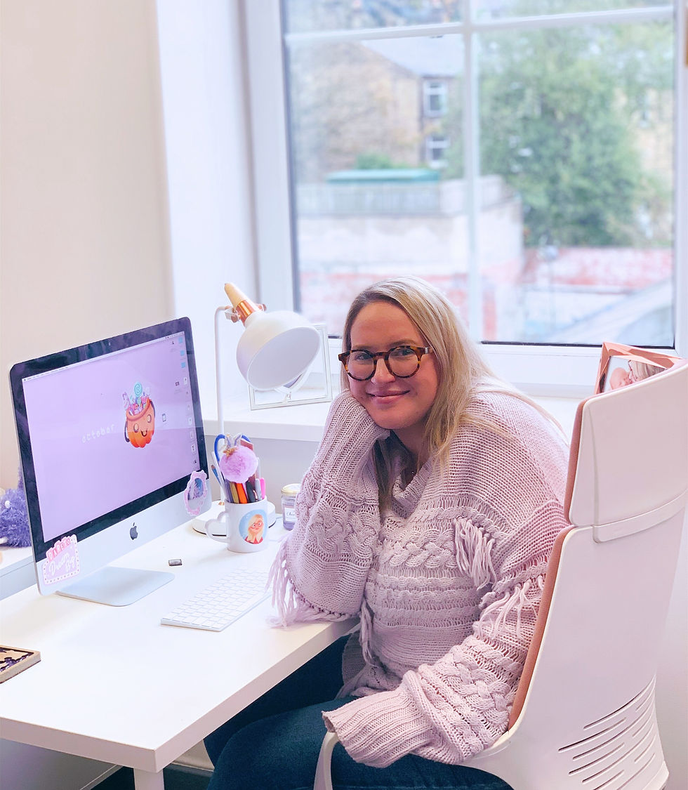 Emily sat at her desk in her new studio.
