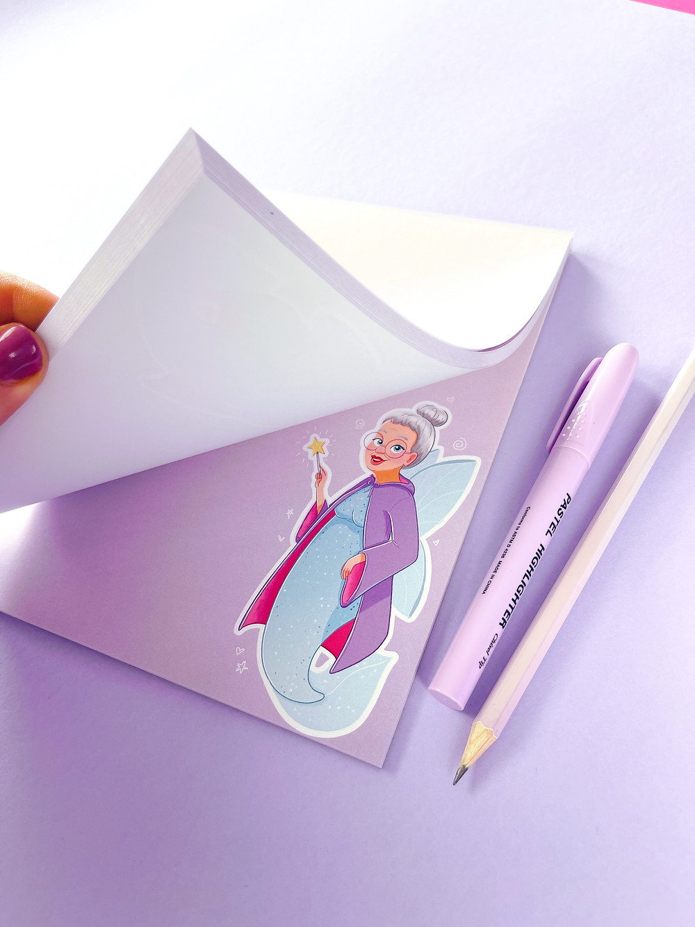 A notepad featuring a Fairy Godmother character by Emily Harvey Art