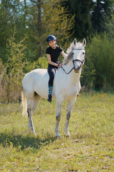 Girl riding a horse bareback