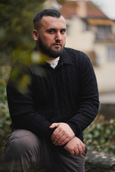 portrait of a man in a black pullover