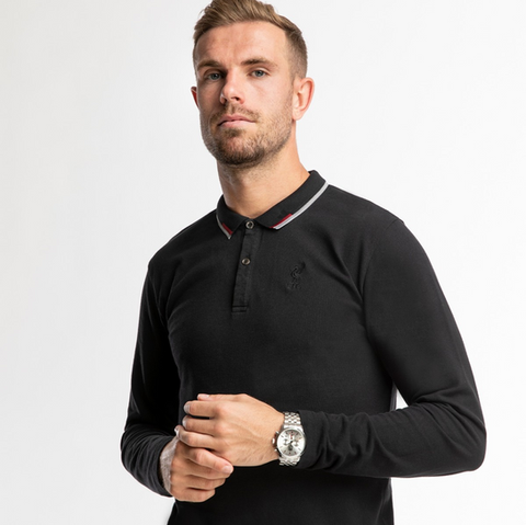 Jordan Henderson wearing long sleeved black Liverpool FC polo shirt