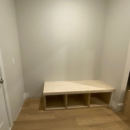 Framing phase of a handcrafted hall tree with shoe storage.