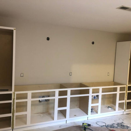 Installing custom drawers and hardware in a large bathroom vanity.