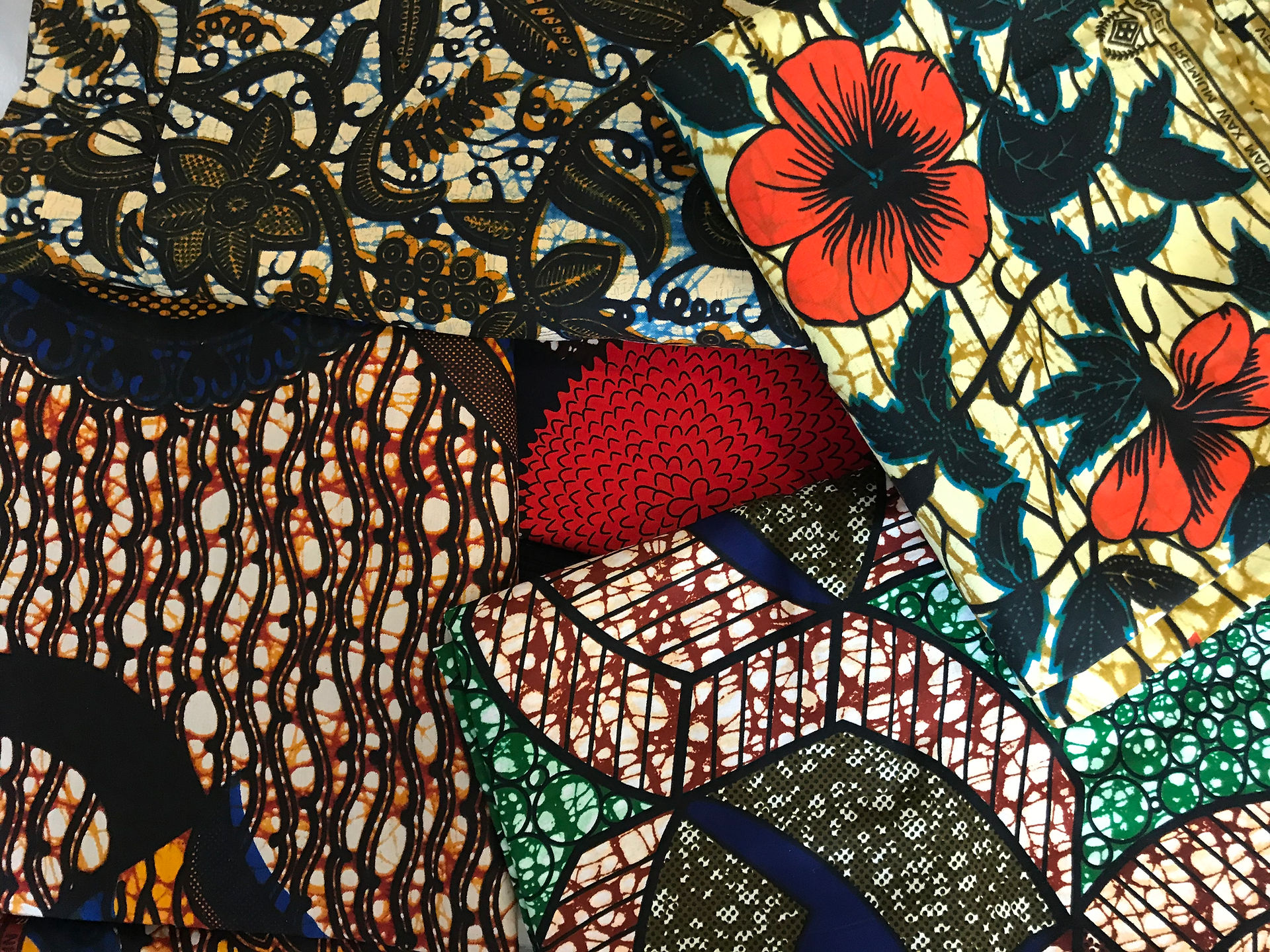 Kitenges of Kenya. with bright bold plant and flower designs and colours.