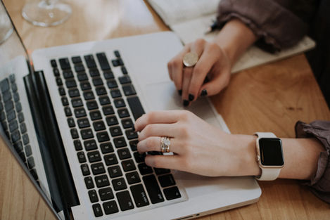 women's hands typing on pc