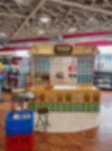 Display photography of a traditional market stall. This exhibit mimics an old-fashioned shop stocked with grains, set against a backdrop of a modern retail environment.